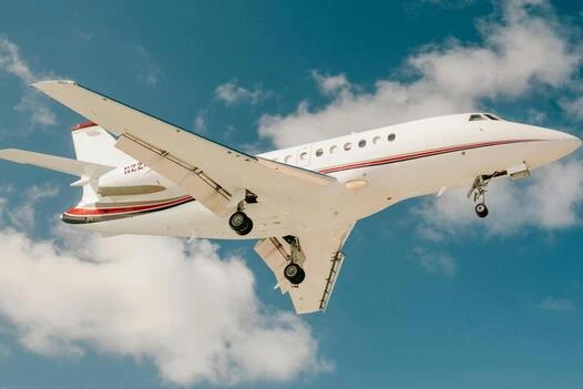 private jet flying next to clouds